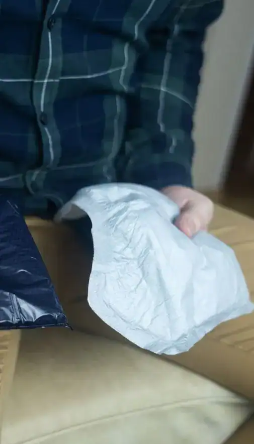 Image of man holding incontinence pads as part of overactive bladder treatment Swindon