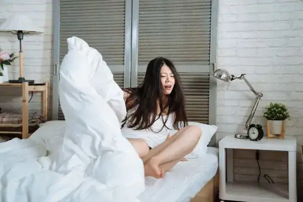 Image of woman getting up because of nighttime leaks Swindon